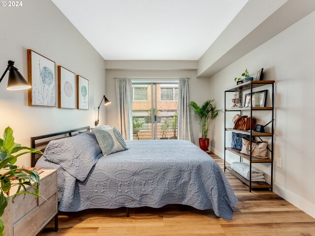 bedroom featuring light hardwood / wood-style flooring and connected bathroom