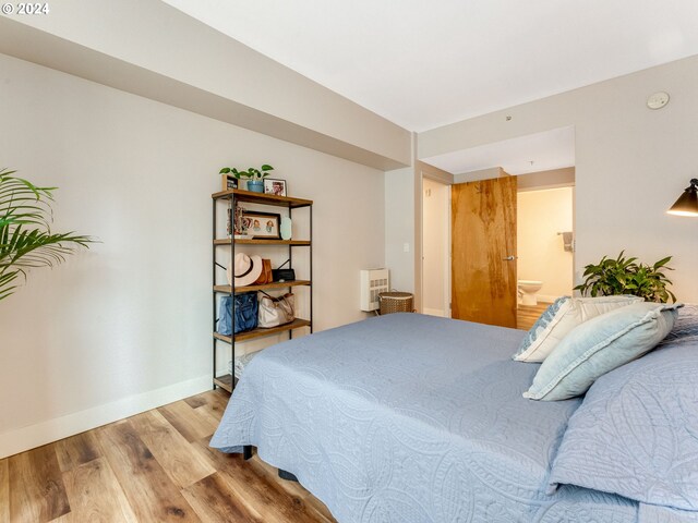 bathroom with a shower with shower door, toilet, hardwood / wood-style floors, and vanity