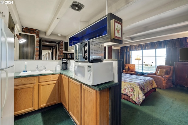 interior space with sink, beamed ceiling, dark carpet, and white refrigerator