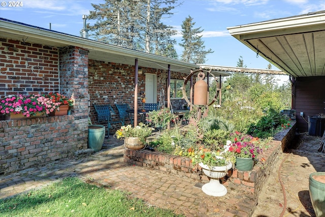 view of exterior entry featuring a patio