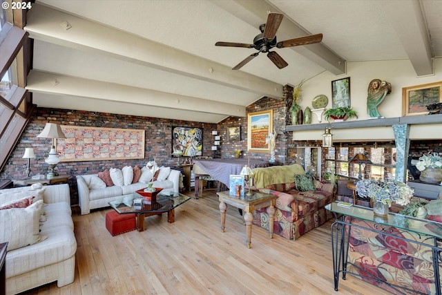 living room with light wood-type flooring, brick wall, ceiling fan, a healthy amount of sunlight, and lofted ceiling with beams