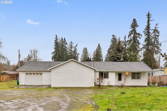 view of front of property featuring a garage and a front lawn