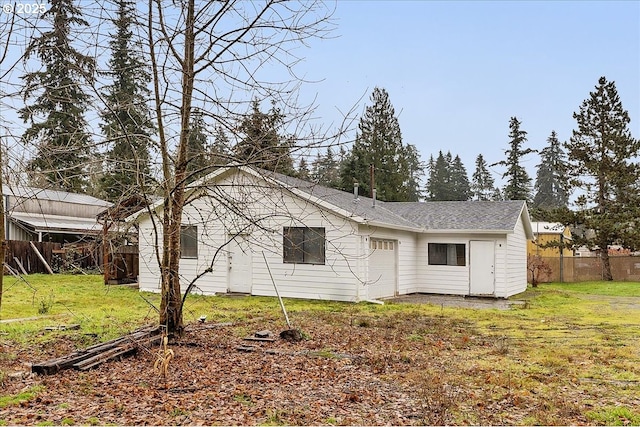 rear view of property featuring a yard