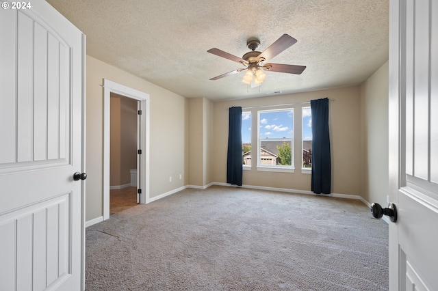 unfurnished bedroom featuring a textured ceiling, ceiling fan, and carpet floors