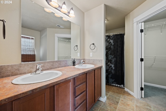 bathroom with double vanity and tile patterned floors