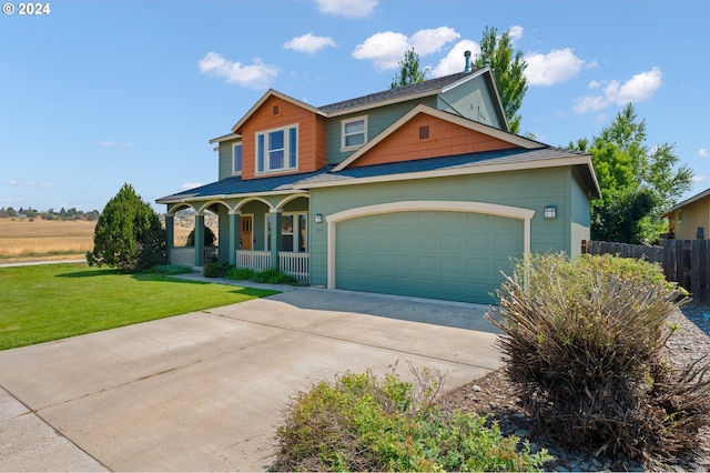 view of front facade with a porch, a front yard, and a garage