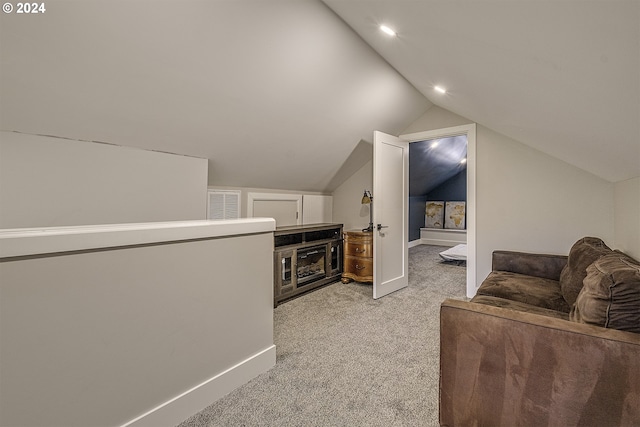 interior space featuring light colored carpet and lofted ceiling