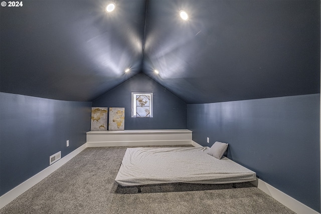 bedroom featuring carpet and vaulted ceiling