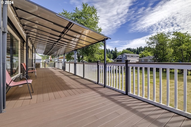 wooden terrace featuring a yard