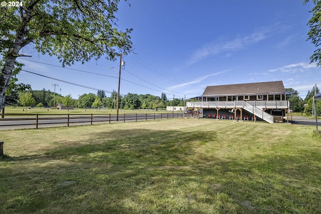 view of yard featuring a rural view and a deck