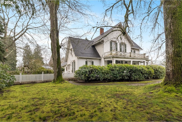 view of side of property with a lawn