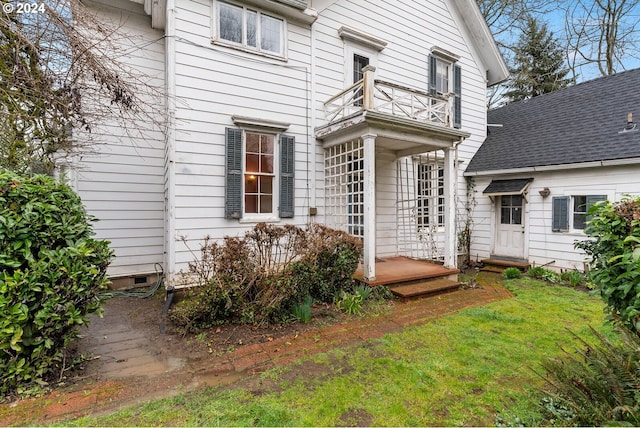 exterior space featuring a yard and a balcony