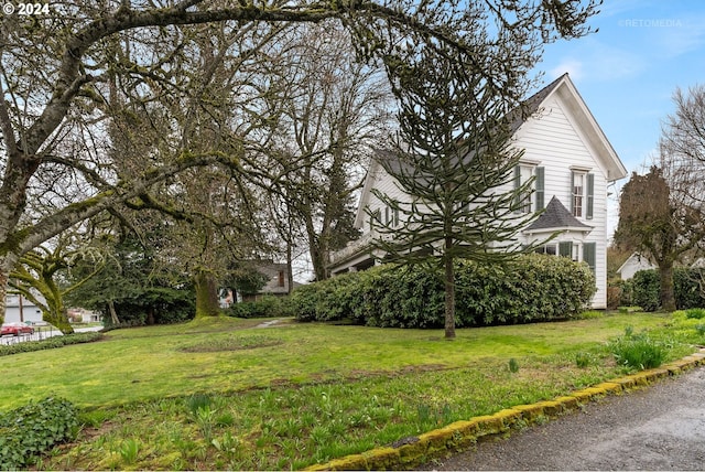 view of property exterior with a yard