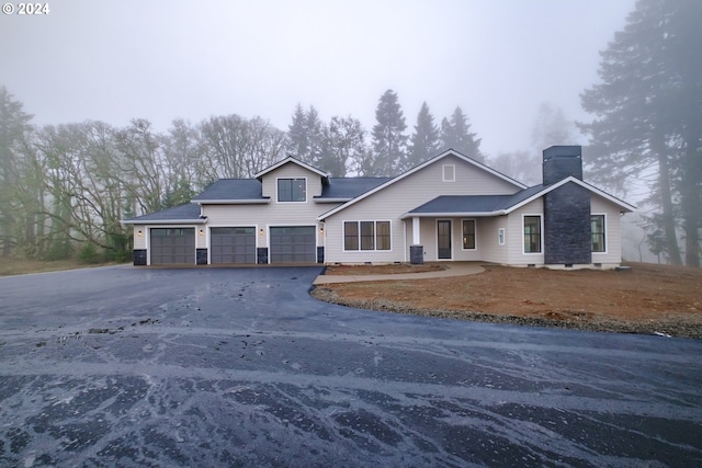 view of front of home featuring a garage and central AC unit