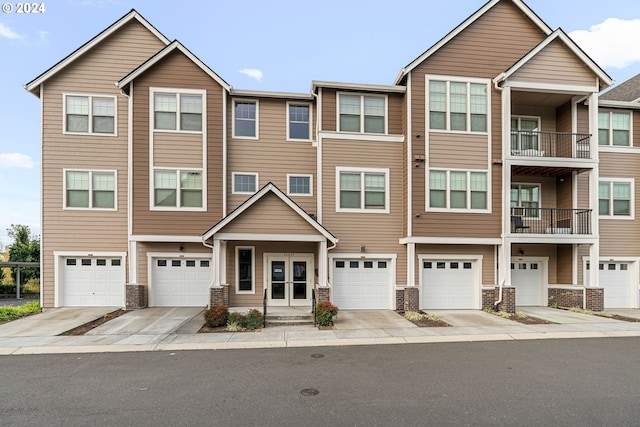 view of property featuring a balcony and a garage