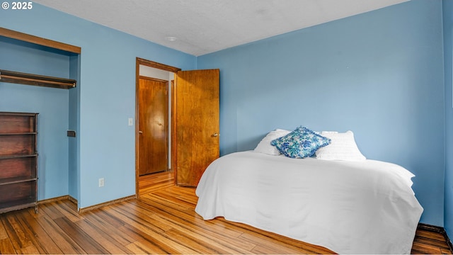 bedroom featuring a closet and light hardwood / wood-style flooring