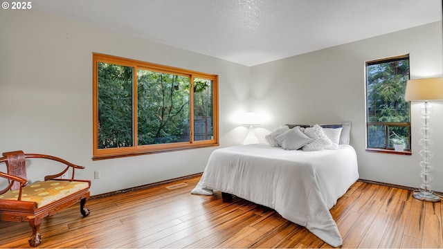 bedroom with hardwood / wood-style flooring