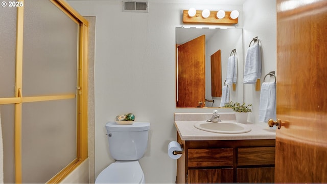 full bathroom with toilet, vanity, and shower / bath combination with glass door