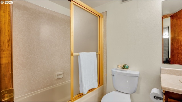 full bathroom featuring toilet, enclosed tub / shower combo, and vanity