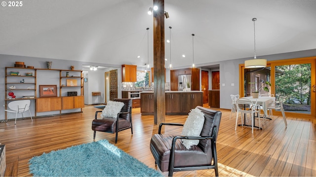 living room featuring light wood-type flooring and lofted ceiling