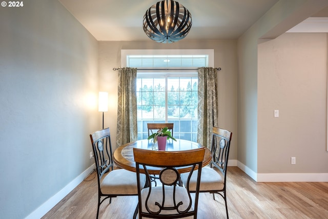 dining room featuring light hardwood / wood-style floors and a notable chandelier