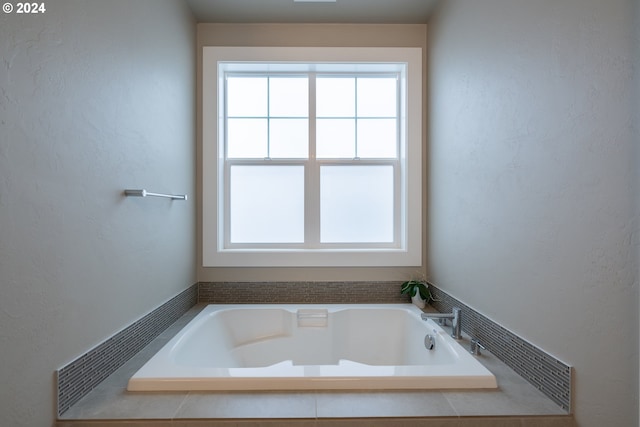 bathroom with a relaxing tiled tub