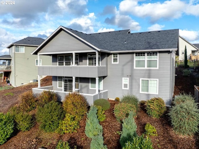 rear view of property with a balcony