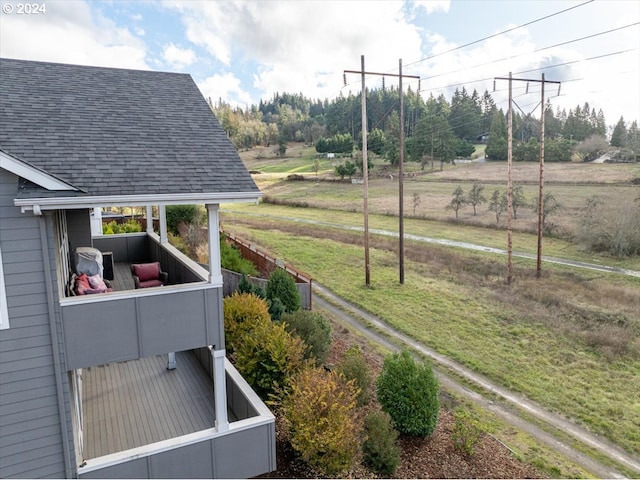 view of yard featuring a rural view and a balcony