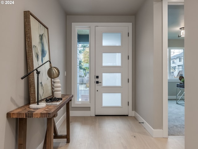 entryway featuring plenty of natural light and light hardwood / wood-style flooring