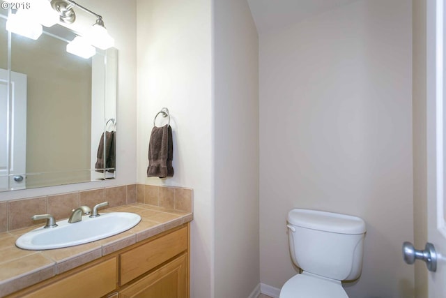bathroom featuring toilet and vanity