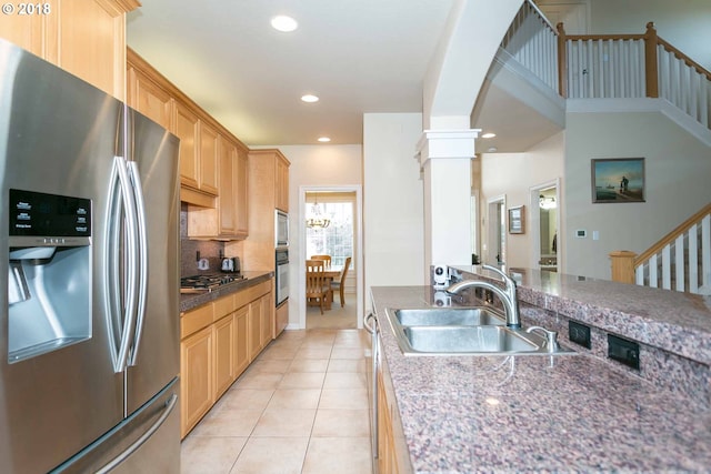 kitchen with stainless steel appliances, a sink, decorative columns, recessed lighting, and light tile patterned flooring