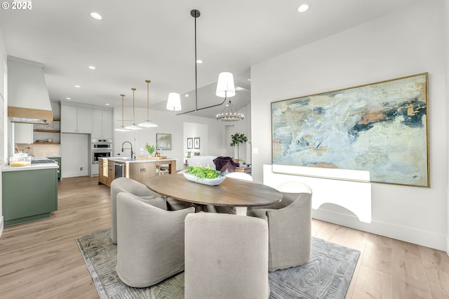 dining space featuring light wood-type flooring, baseboards, and recessed lighting