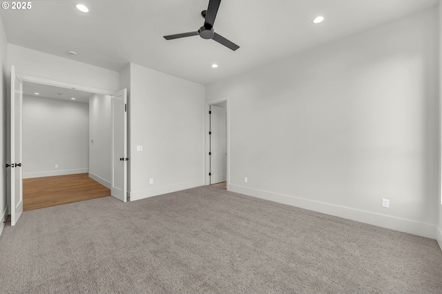 empty room with ceiling fan, baseboards, light colored carpet, and recessed lighting