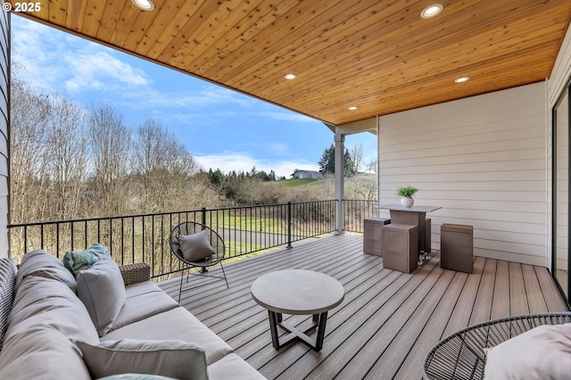 wooden deck with an outdoor living space