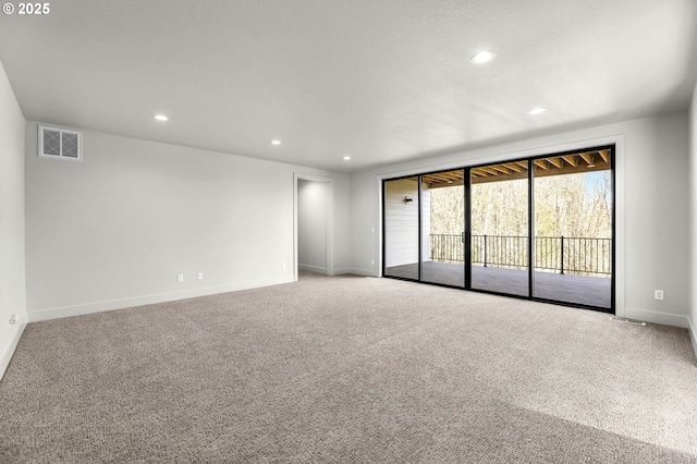 empty room featuring baseboards, visible vents, carpet flooring, and recessed lighting