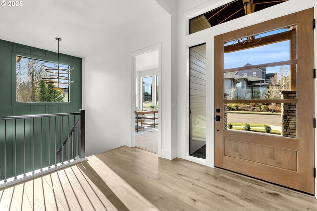 entryway with lofted ceiling and light wood-type flooring