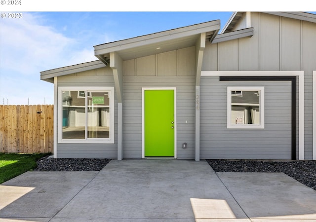 view of exterior entry with a patio area