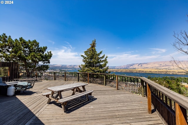 wooden deck featuring a water and mountain view