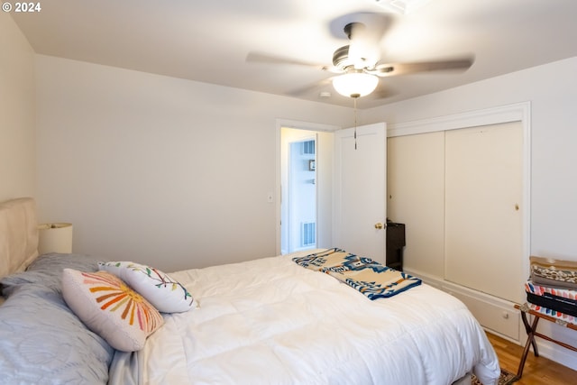 bedroom with ceiling fan, hardwood / wood-style floors, and a closet