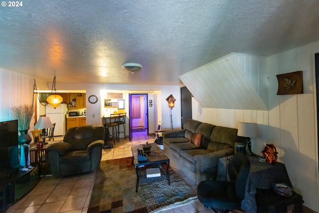 living room featuring light tile patterned floors and a textured ceiling