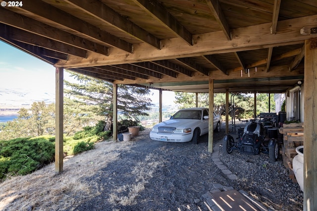 view of parking / parking lot featuring a carport