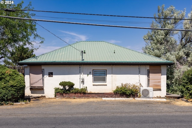 view of front of property featuring ac unit