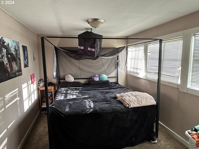 carpeted bedroom featuring a textured ceiling and multiple windows