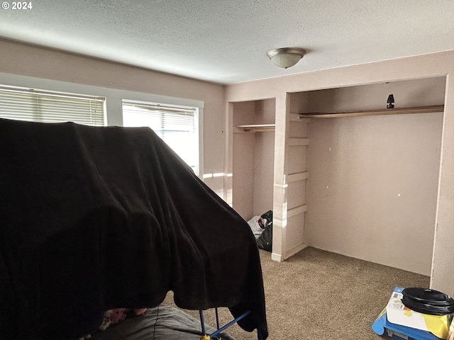 carpeted bedroom featuring a textured ceiling