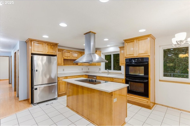 kitchen featuring black appliances, a center island, island exhaust hood, and light brown cabinets