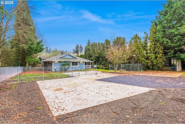 back of property featuring volleyball court