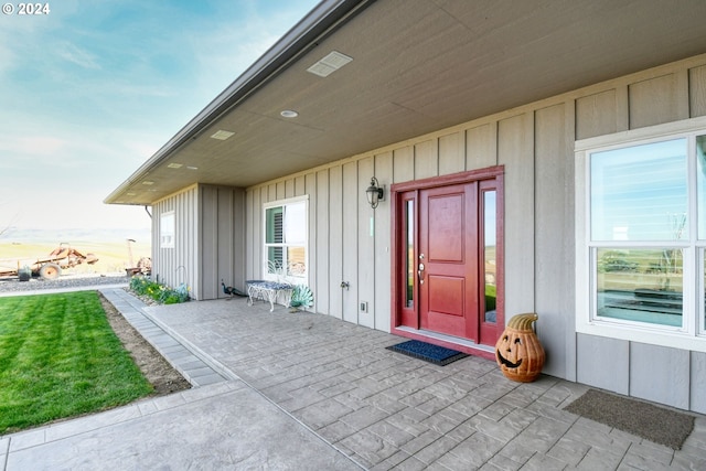 view of exterior entry featuring a patio