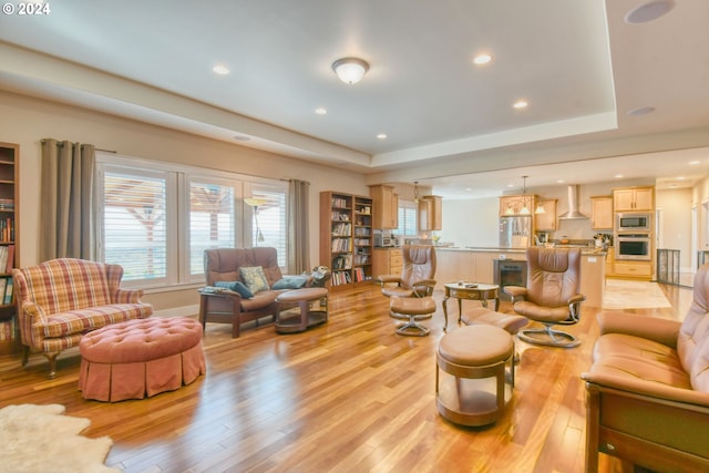 living room with a healthy amount of sunlight and light hardwood / wood-style floors