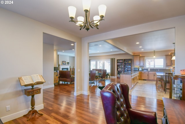 dining space with light hardwood / wood-style flooring, a chandelier, and plenty of natural light