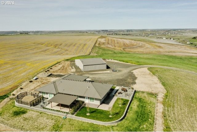 birds eye view of property with a rural view